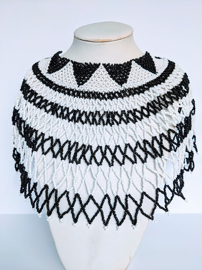 This Necklace is handmade out of glass bead with adjustable loop at the back. The necklace is about 59 cm long.