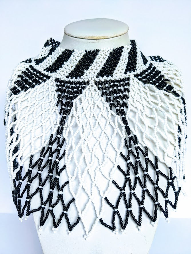 This Necklace is handmade out of glass bead with adjustable loop at the back. The necklace is about 59 cm long.