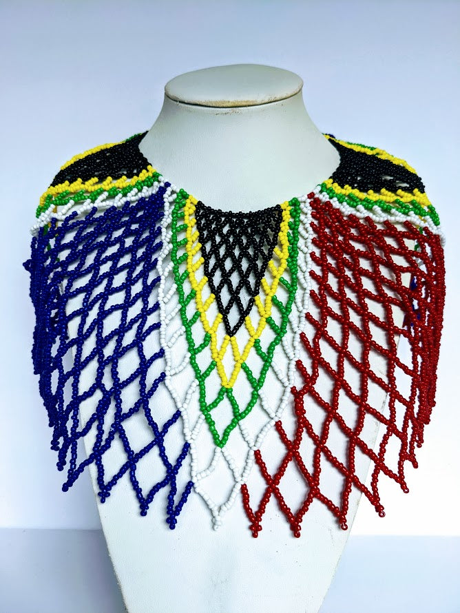 This necklace is handmade out of glass beads with an adjustable loop at the back. The necklace is around 59 cm long.