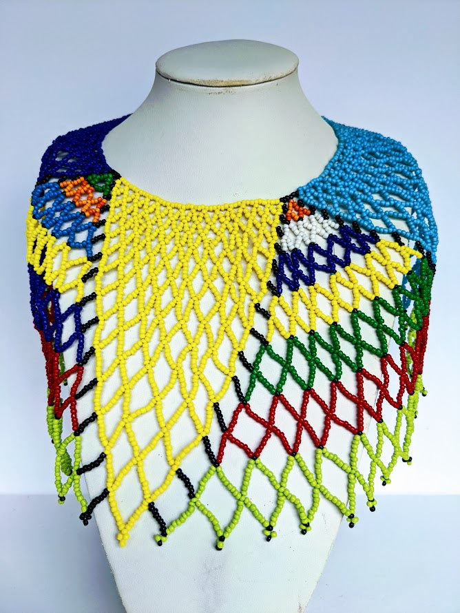 This necklace is handmade out of glass beads with an adjustable loop at the back. The necklace is around 59 cm long.