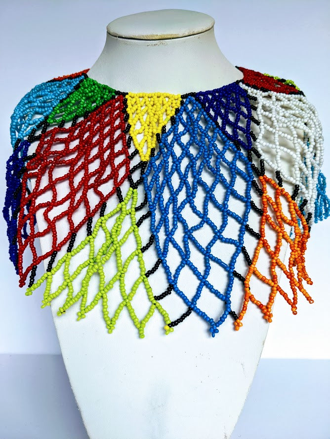 This necklace is handmade out of glass beads with an adjustable loop at the back. The necklace is around 59 cm long.