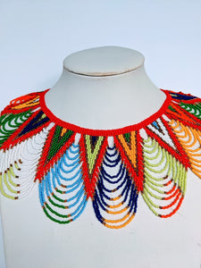 This necklace is handmade out of glass bead with an adjustable loop at the back. The necklace is about 59 cm long. 