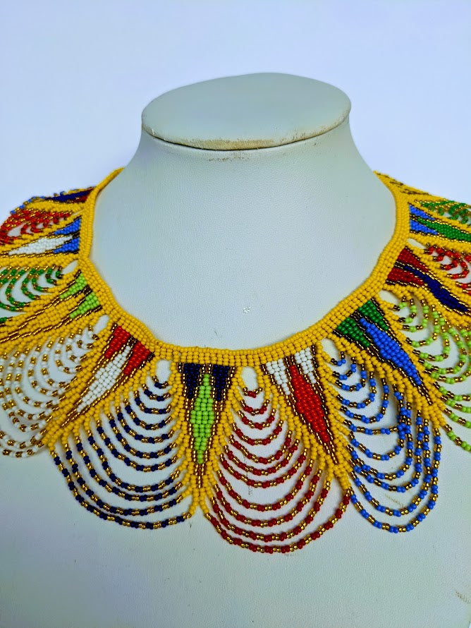 This necklace is handmade out of glass bead with an adjustable loop at the back. The necklace is about 59 cm long. 